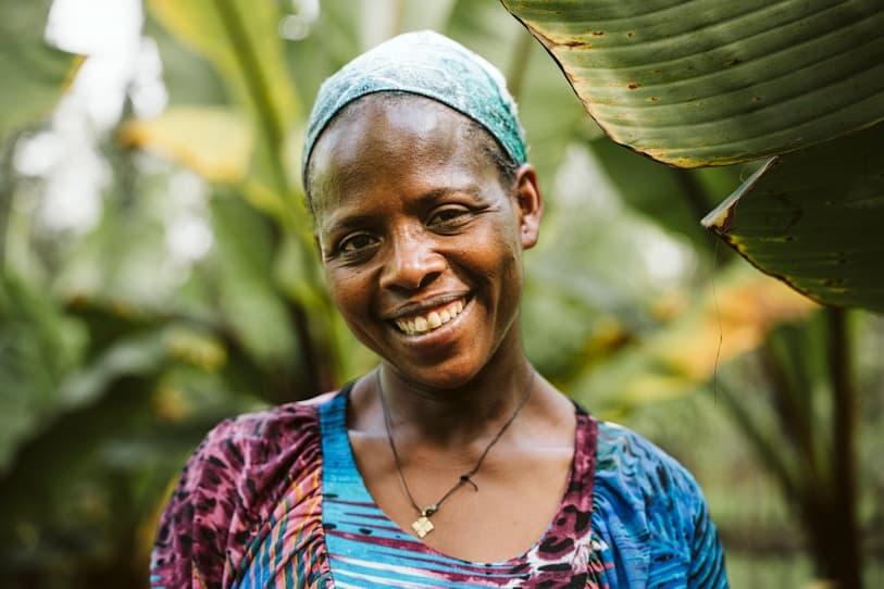A woman standing in front of a banana tree
